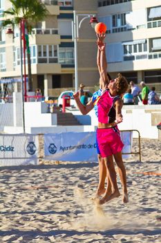 CADIZ, SPAIN - JULY 19: Unidentified players compete in a match between Zonabalonmano.com and CadizSur Seguros BMPY in the 19th league of beach handball of Cadiz on July 19, 2011 in Cadiz, Spain