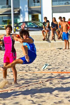 CADIZ, SPAIN - JULY 19: Unidentified players compete in a match between Zonabalonmano.com and CadizSur Seguros BMPY in the 19th league of beach handball of Cadiz on July 19, 2011 in Cadiz, Spain