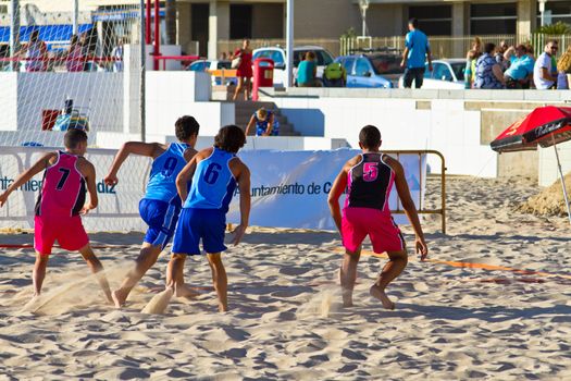 CADIZ, SPAIN - JULY 19: Unidentified players compete in a match between Zonabalonmano.com and CadizSur Seguros BMPY in the 19th league of beach handball of Cadiz on July 19, 2011 in Cadiz, Spain