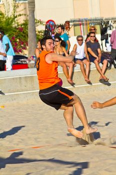 CADIZ, SPAIN - JULY 19: Unidentified players compete in a match between Los Negritos and Autoescuela Barquin in the 19th league of beach handball of Cadiz on July 19, 2011 in Cadiz, Spain
