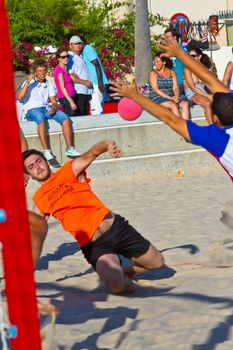 CADIZ, SPAIN - JULY 19: Unidentified players compete in a match between Los Negritos and Autoescuela Barquin in the 19th league of beach handball of Cadiz on July 19, 2011 in Cadiz, Spain