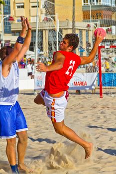 CADIZ, SPAIN - JULY 19: Unidentified players compete in a match between Los Negritos and Autoescuela Barquin in the 19th league of beach handball of Cadiz on July 19, 2011 in Cadiz, Spain