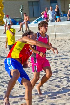 CADIZ, SPAIN - JULY 19: Unidentified players compete in a match between Zonabalonmano.com and CadizSur Seguros BMPY in the 19th league of beach handball of Cadiz on July 19, 2011 in Cadiz, Spain
