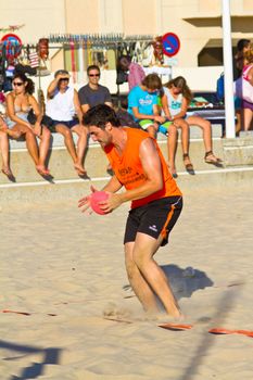 CADIZ, SPAIN - JULY 19: Unidentified players compete in a match between Los Negritos and Autoescuela Barquin in the 19th league of beach handball of Cadiz on July 19, 2011 in Cadiz, Spain