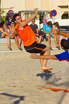 CADIZ, SPAIN - JULY 19: Unidentified players compete in a match between Los Negritos and Autoescuela Barquin in the 19th league of beach handball of Cadiz on July 19, 2011 in Cadiz, Spain
