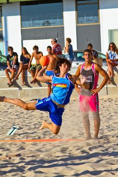 CADIZ, SPAIN - JULY 19: Unidentified players compete in a match between Zonabalonmano.com and CadizSur Seguros BMPY in the 19th league of beach handball of Cadiz on July 19, 2011 in Cadiz, Spain