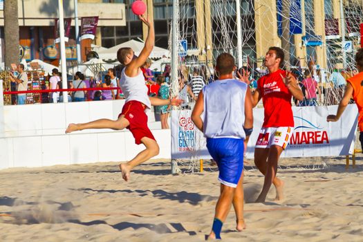 CADIZ, SPAIN - JULY 19: Unidentified players compete in a match between Los Negritos and Autoescuela Barquin in the 19th league of beach handball of Cadiz on July 19, 2011 in Cadiz, Spain