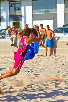 CADIZ, SPAIN - JULY 19: Unidentified players compete in a match between Zonabalonmano.com and CadizSur Seguros BMPY in the 19th league of beach handball of Cadiz on July 19, 2011 in Cadiz, Spain