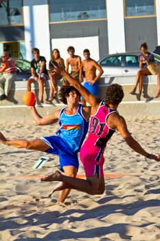 CADIZ, SPAIN - JULY 19: Unidentified players compete in a match between Zonabalonmano.com and CadizSur Seguros BMPY in the 19th league of beach handball of Cadiz on July 19, 2011 in Cadiz, Spain