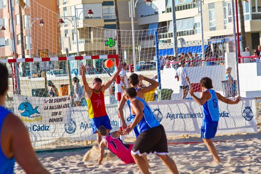 CADIZ, SPAIN - JULY 19: Unidentified players compete in a match between Zonabalonmano.com and CadizSur Seguros BMPY in the 19th league of beach handball of Cadiz on July 19, 2011 in Cadiz, Spain