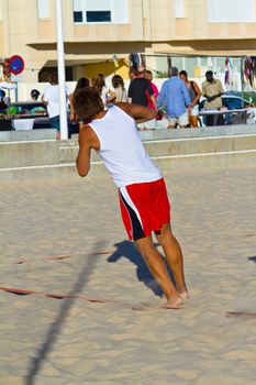 CADIZ, SPAIN - JULY 19: Unidentified players compete in a match between Los Negritos and Autoescuela Barquin in the 19th league of beach handball of Cadiz on July 19, 2011 in Cadiz, Spain