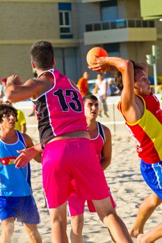 CADIZ, SPAIN - JULY 19: Unidentified players compete in a match between Zonabalonmano.com and CadizSur Seguros BMPY in the 19th league of beach handball of Cadiz on July 19, 2011 in Cadiz, Spain