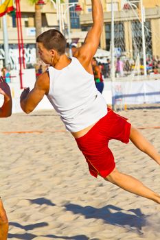 CADIZ, SPAIN - JULY 19: Unidentified players compete in a match between Los Negritos and Autoescuela Barquin in the 19th league of beach handball of Cadiz on July 19, 2011 in Cadiz, Spain