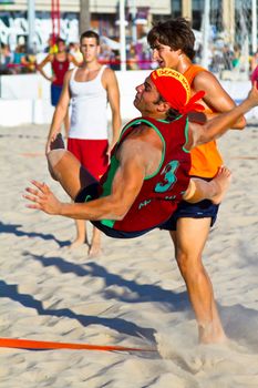 CADIZ, SPAIN - JULY 19: Unidentified players compete in a match between Los Negritos and Autoescuela Barquin in the 19th league of beach handball of Cadiz on July 19, 2011 in Cadiz, Spain