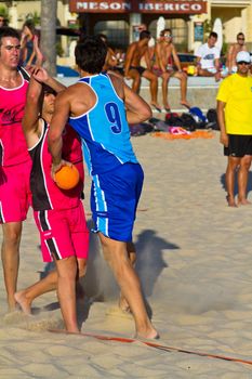CADIZ, SPAIN - JULY 19: Unidentified players compete in a match between Zonabalonmano.com and CadizSur Seguros BMPY in the 19th league of beach handball of Cadiz on July 19, 2011 in Cadiz, Spain