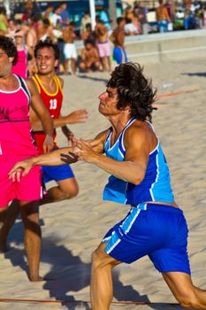 CADIZ, SPAIN - JULY 19: Unidentified players compete in a match between Zonabalonmano.com and CadizSur Seguros BMPY in the 19th league of beach handball of Cadiz on July 19, 2011 in Cadiz, Spain