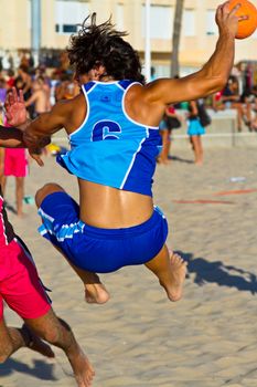 CADIZ, SPAIN - JULY 19: Unidentified players compete in a match between Zonabalonmano.com and CadizSur Seguros BMPY in the 19th league of beach handball of Cadiz on July 19, 2011 in Cadiz, Spain