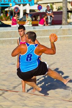 CADIZ, SPAIN - JULY 19: Unidentified players compete in a match between Zonabalonmano.com and CadizSur Seguros BMPY in the 19th league of beach handball of Cadiz on July 19, 2011 in Cadiz, Spain