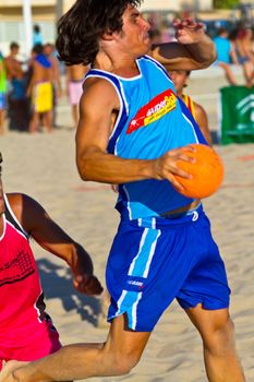 CADIZ, SPAIN - JULY 19: Unidentified players compete in a match between Zonabalonmano.com and CadizSur Seguros BMPY in the 19th league of beach handball of Cadiz on July 19, 2011 in Cadiz, Spain