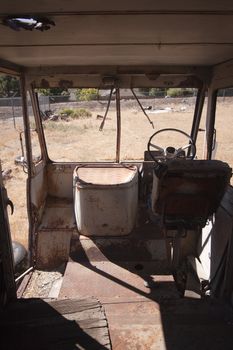 An old abandoned vintage delivery truck van in a field