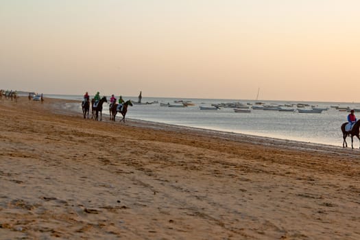 SANLUCAR DE BARRAMEDA, CADIZ, SPAIN - AUGUST 10: Unidentified riders at the start of race horses on Sanlucar de Barrameda beach on August 10, 2011 in Sanlucar de Barrameda, Cadiz, Spain.