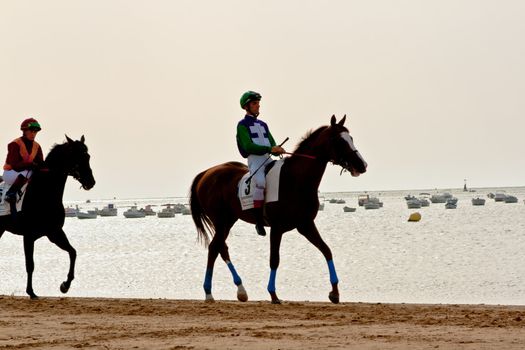 SANLUCAR DE BARRAMEDA, CADIZ, SPAIN - AUGUST 10: Unidentified rider at the start of race horses on Sanlucar de Barrameda beach on August 10, 2011 in Sanlucar de Barrameda, Cadiz, Spain.
