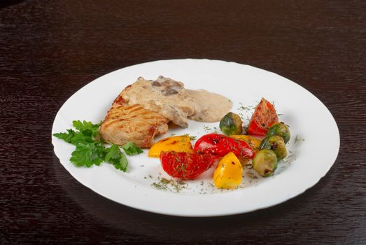 pork steak with mushroom sauce and grilled vegetables