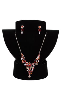 a necklace with pendants and earrings on a white background