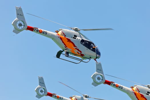 CADIZ, SPAIN-SEP 12: Helicopters of the Patrulla Aspa taking part in an exhibition on the 3rd airshow of Cadiz on Sep 12, 2010, in Cadiz, Spain