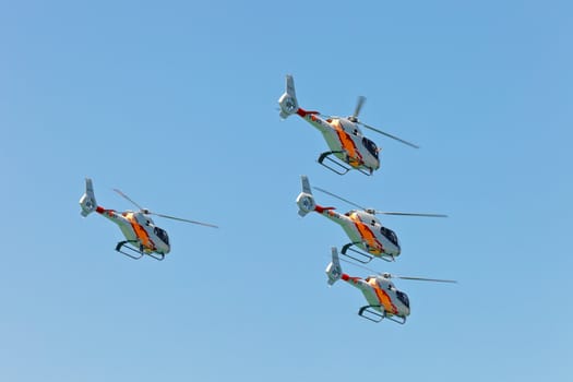 CADIZ, SPAIN-SEP 12: Helicopters of the Patrulla Aspa taking part in an exhibition on the 3rd airshow of Cadiz on Sep 12, 2010, in Cadiz, Spain