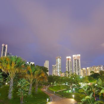 Colorful city night scene with modern buildings and green trees in park In Kuala Lumpur, Malaysia, Asia.