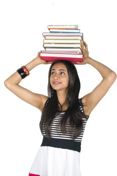 Young teenage girl holding books. Isolated on a white background.