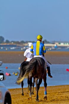 SANLUCAR DE BARRAMEDA, CADIZ, SPAIN - AUGUST 10: Unidentified rider at the start of race horses on Sanlucar de Barrameda beach on August 10, 2011 in Sanlucar de Barrameda, Cadiz, Spain.