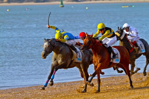 SANLUCAR DE BARRAMEDA, CADIZ, SPAIN - AUGUST 10: Unidentified rider at the start of race horses on Sanlucar de Barrameda beach on August 10, 2011 in Sanlucar de Barrameda, Cadiz, Spain.