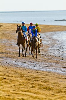 SANLUCAR DE BARRAMEDA, CADIZ, SPAIN - AUGUST 10: Unidentified rider at the start of race horses on Sanlucar de Barrameda beach on August 10, 2011 in Sanlucar de Barrameda, Cadiz, Spain.