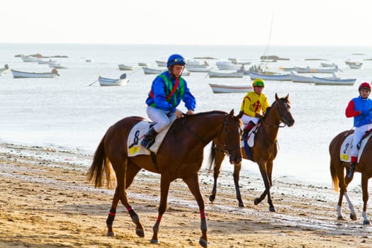 SANLUCAR DE BARRAMEDA, CADIZ, SPAIN - AUGUST 10: Unidentified rider at the start of race horses on Sanlucar de Barrameda beach on August 10, 2011 in Sanlucar de Barrameda, Cadiz, Spain.