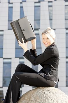 sitting young businesswoman with a briefcase