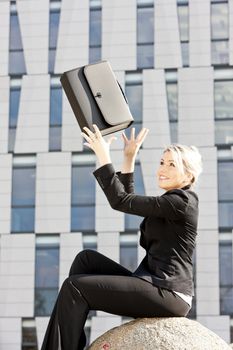 sitting young businesswoman with a briefcase