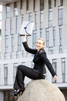 sitting young businesswoman with a briefcase