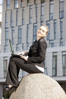 sitting young businesswoman with a notebook