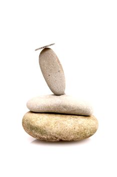 Coin on a pebble stack as a symbol for financial balance...........