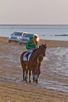 SANLUCAR DE BARRAMEDA, CADIZ, SPAIN - AUGUST 10: Unidentified riders at the start of race horses on Sanlucar de Barrameda beach on August 10, 2011 in Sanlucar de Barrameda, Cadiz, Spain.
