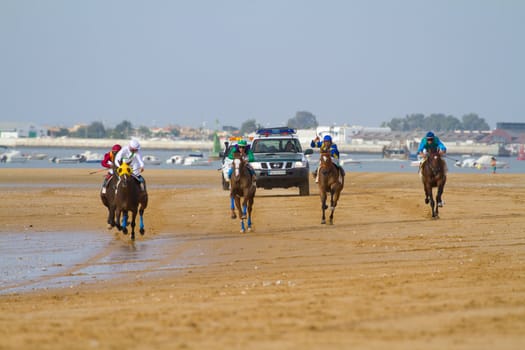 SANLUCAR DE BARRAMEDA, CADIZ, SPAIN - AUGUST 11: Unidentified rider at the start of race horses on Sanlucar de Barrameda beach on August 11, 2011 in Sanlucar de Barrameda, Cadiz, Spain.