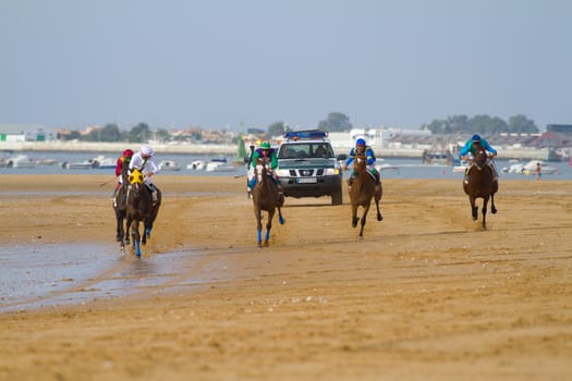SANLUCAR DE BARRAMEDA, CADIZ, SPAIN - AUGUST 11: Unidentified rider at the start of race horses on Sanlucar de Barrameda beach on August 11, 2011 in Sanlucar de Barrameda, Cadiz, Spain.