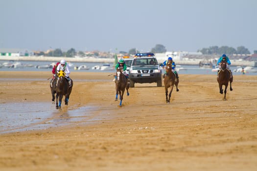 SANLUCAR DE BARRAMEDA, CADIZ, SPAIN - AUGUST 11: Unidentified rider at the start of race horses on Sanlucar de Barrameda beach on August 11, 2011 in Sanlucar de Barrameda, Cadiz, Spain.