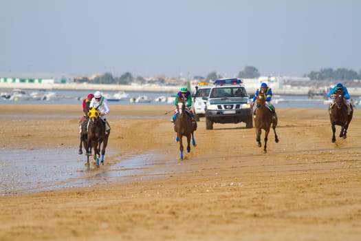 SANLUCAR DE BARRAMEDA, CADIZ, SPAIN - AUGUST 11: Unidentified rider at the start of race horses on Sanlucar de Barrameda beach on August 11, 2011 in Sanlucar de Barrameda, Cadiz, Spain.