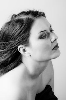 Voluptuous look of brunette young woman. Black and white