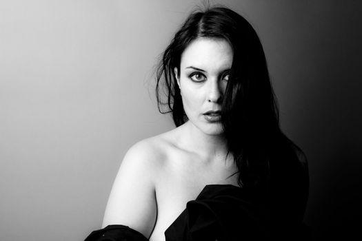 Voluptuous look of brunette young woman. Black and white