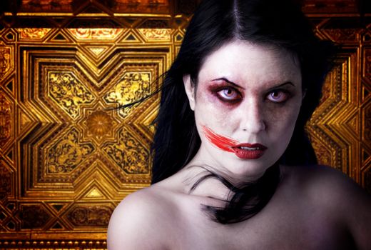 Woman vampire with blood in his mouth. Gothic Image halloween over gold background