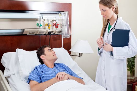 Patient consulting doctor in hospital room